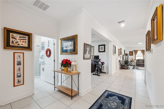 hallway featuring light tile patterned floors and crown molding