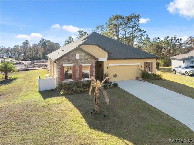 view of front of home with a front yard and a garage