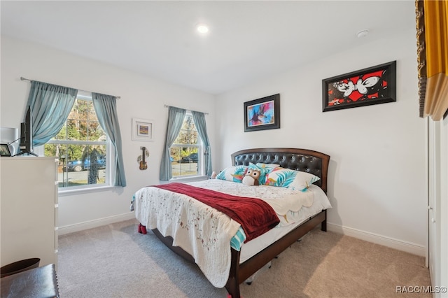 bedroom featuring light carpet