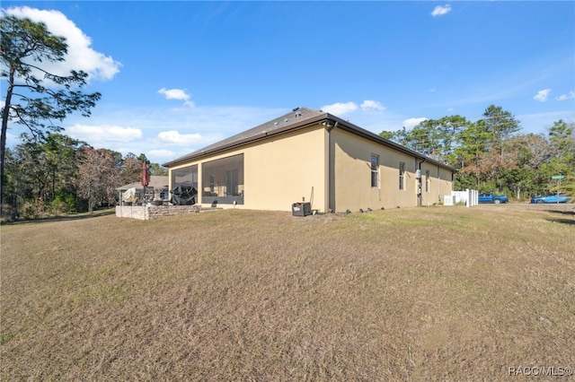 view of side of home featuring a lawn