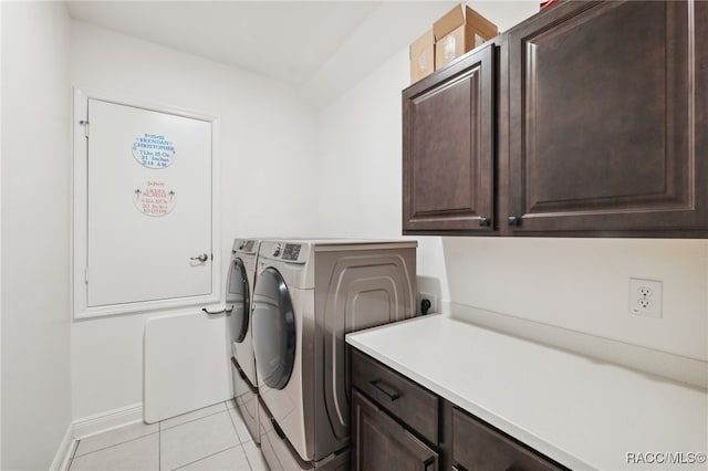 laundry room featuring cabinets, separate washer and dryer, and light tile patterned flooring