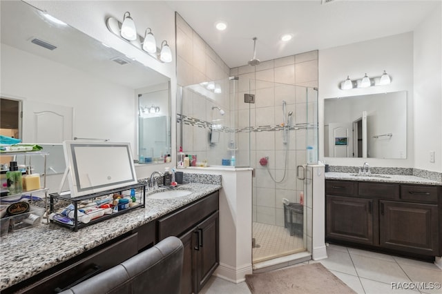 bathroom with tile patterned floors, vanity, and walk in shower