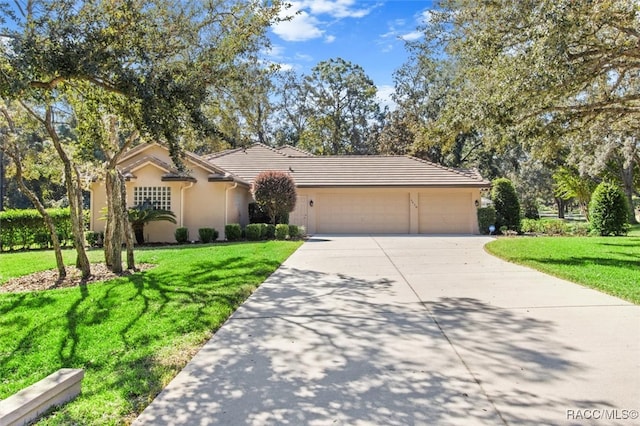 single story home featuring a garage and a front yard