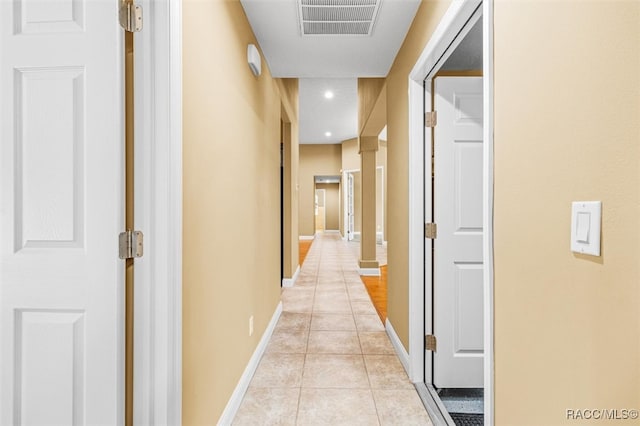 hall featuring light tile patterned floors