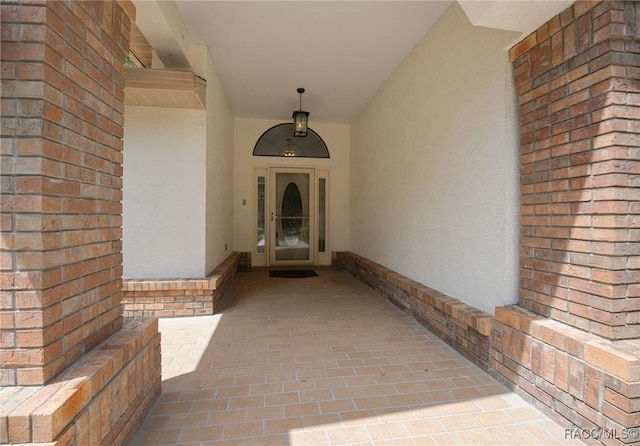 entrance to property featuring stucco siding