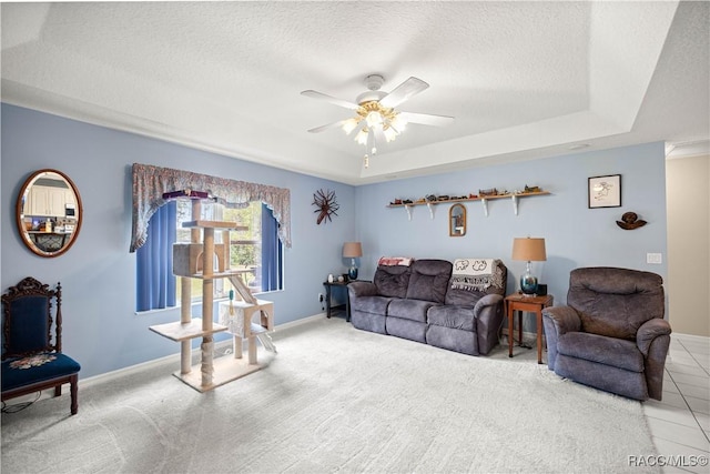 11271 SE 136th Ter, Dunnellon, FL 34431 - living room with a textured ceiling, a raised ceiling, a ceiling fan, and carpet flooring