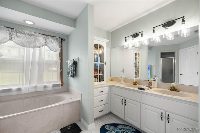 11271 SE 136th Ter, Dunnellon, FL 34431 - full bathroom with tile patterned flooring, double vanity, a garden tub, and a shower stall