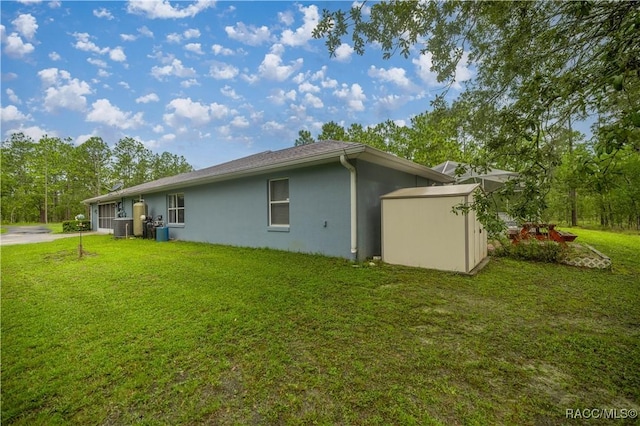 11271 SE 136th Ter, Dunnellon, FL 34431 - view of side of home featuring stucco siding, a shed, and a yard