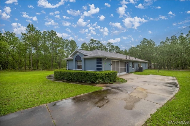11271 SE 136th Ter, Dunnellon, FL 34431 - view of front of property with driveway, a garage, a front yard, and stucco siding