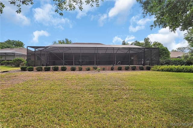 exterior space with glass enclosure and a lawn
