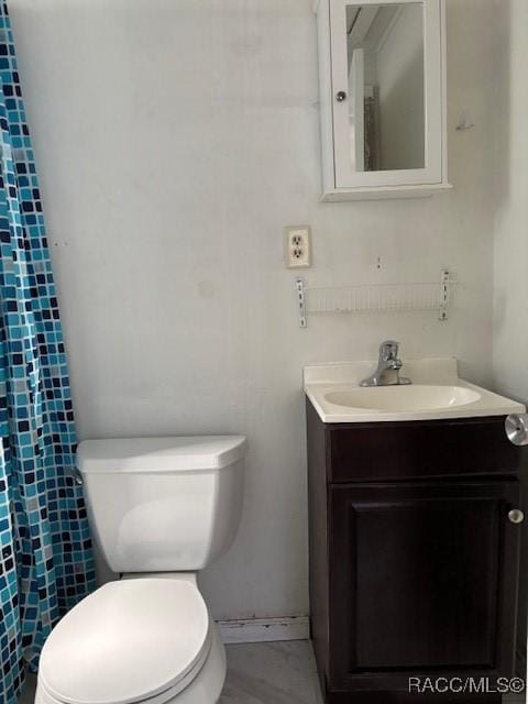 bathroom featuring vanity and toilet