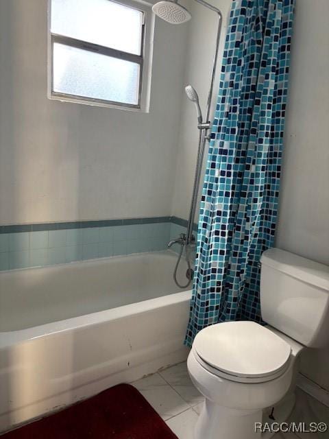 bathroom featuring toilet, tile patterned flooring, and shower / bath combo