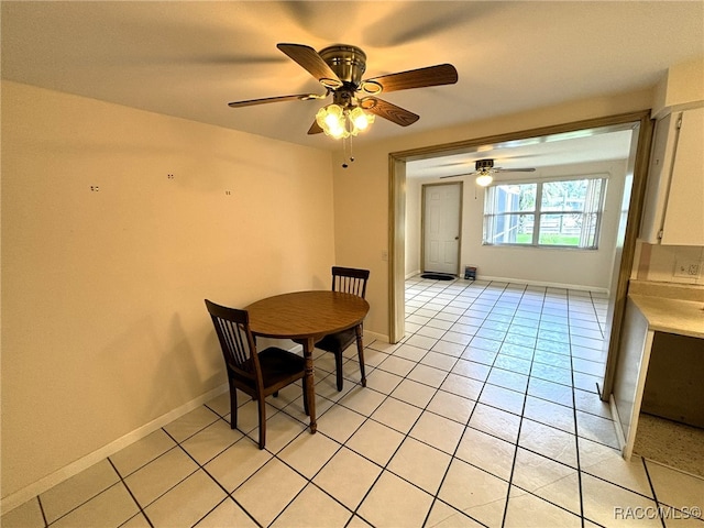 tiled dining area featuring ceiling fan