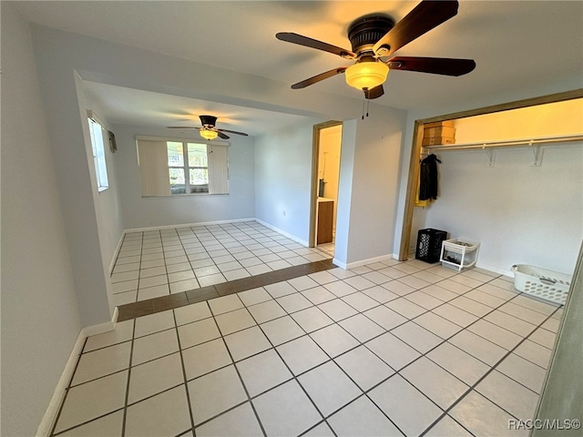 empty room featuring ceiling fan and light tile patterned floors