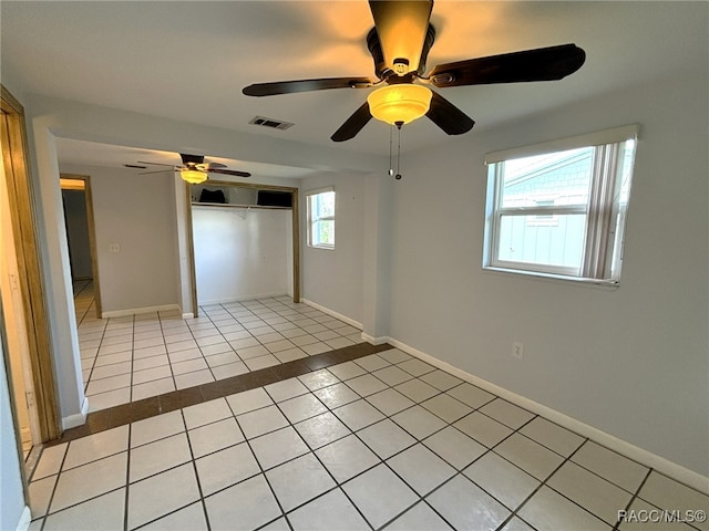 spare room with light tile patterned floors and ceiling fan