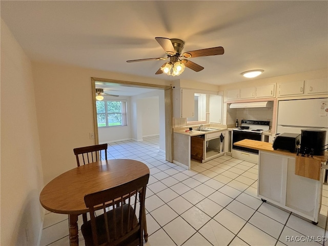 kitchen featuring white range with electric cooktop, white cabinets, sink, ceiling fan, and light tile patterned floors