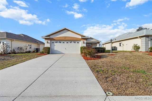 single story home featuring a garage, central AC, and a front lawn