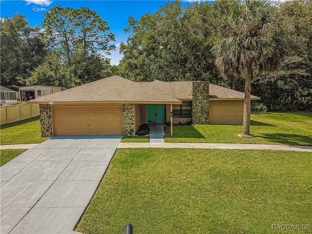 ranch-style house featuring a garage and a front yard