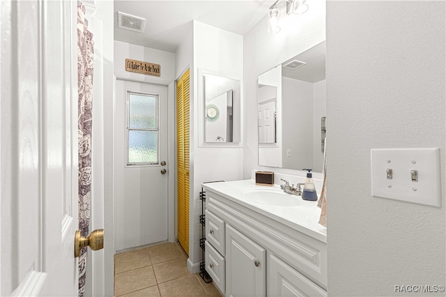 bathroom featuring tile patterned floors and vanity