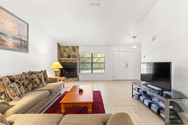 living room with lofted ceiling, a fireplace, and light tile patterned floors