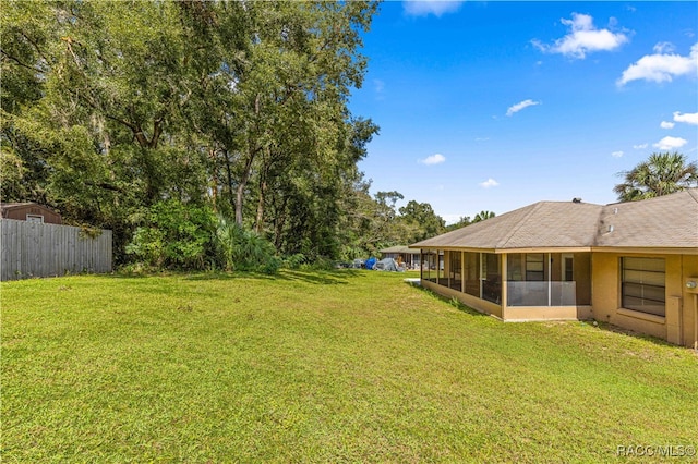 view of yard with a sunroom