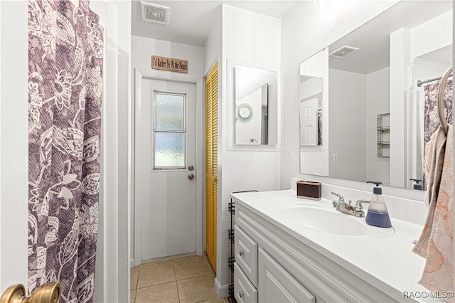 bathroom featuring tile patterned flooring and vanity