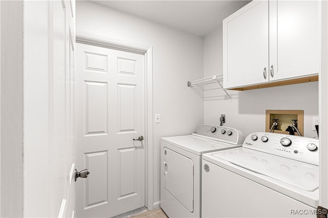 washroom featuring cabinets, independent washer and dryer, a textured ceiling, and light tile patterned floors