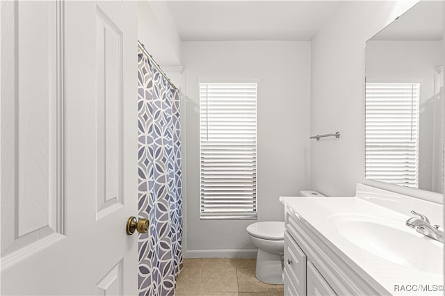 bathroom featuring tile patterned floors, vanity, and toilet