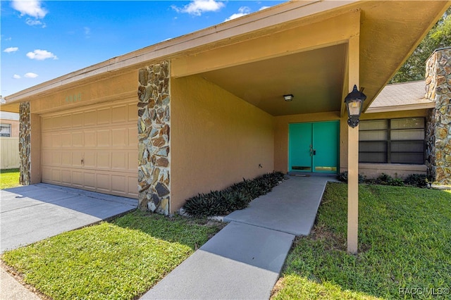 property entrance with a garage and a lawn