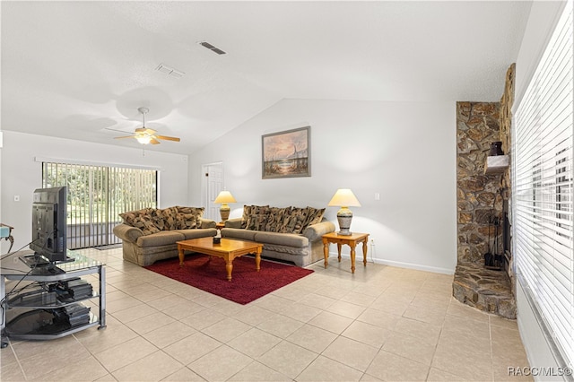 living room featuring ceiling fan, light tile patterned floors, and lofted ceiling