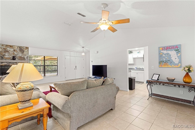 tiled living room with high vaulted ceiling and ceiling fan