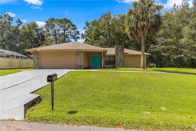 view of front of property featuring a garage and a front lawn