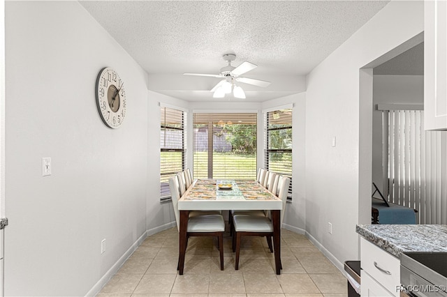 tiled dining area featuring ceiling fan and a textured ceiling