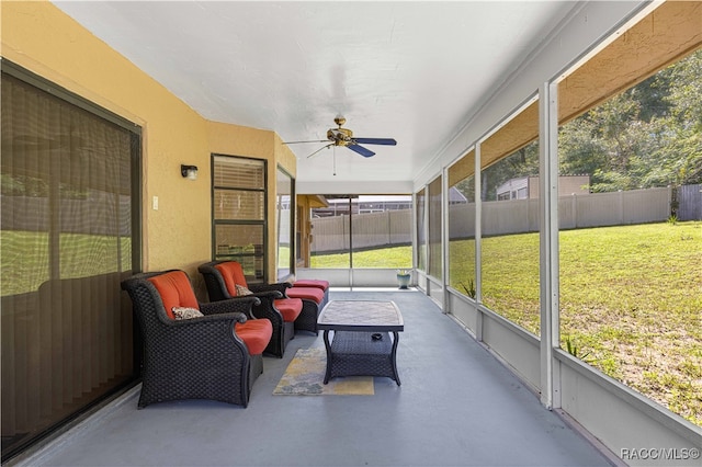 sunroom / solarium featuring ceiling fan