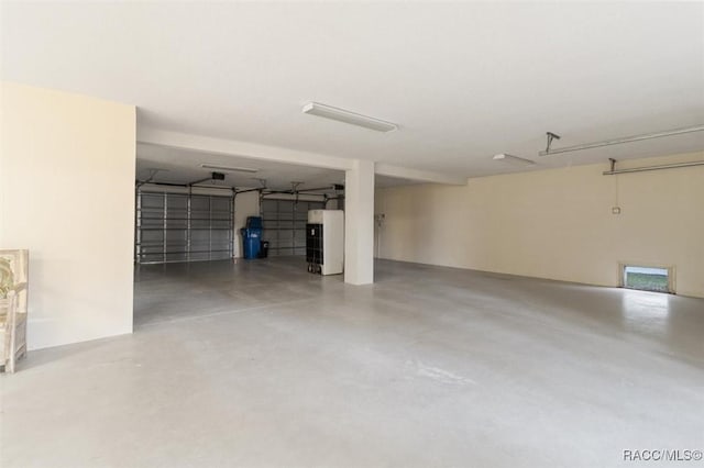 garage featuring white fridge