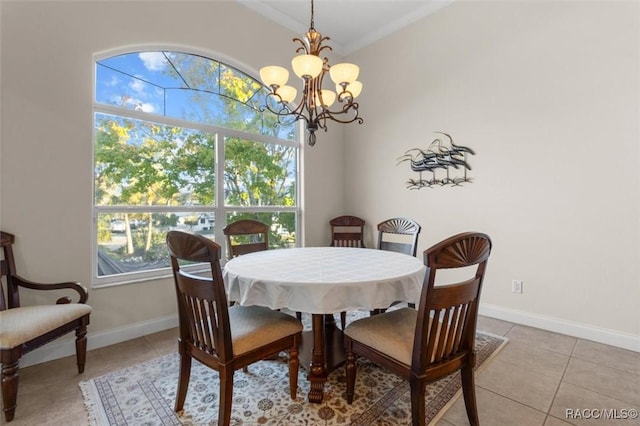 tiled dining area featuring a chandelier and ornamental molding