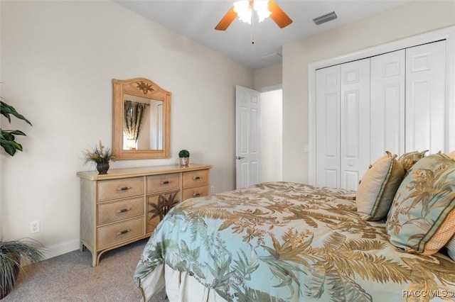 carpeted bedroom with ceiling fan and a closet