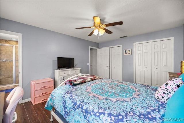 bedroom with baseboards, visible vents, ceiling fan, dark wood-type flooring, and two closets