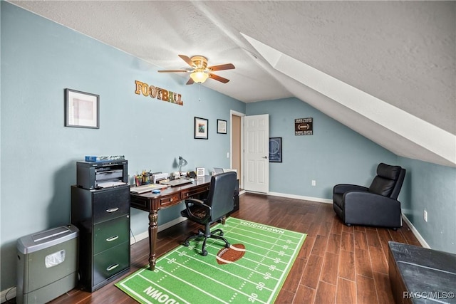 home office with a textured ceiling, dark wood-style flooring, a ceiling fan, baseboards, and lofted ceiling with skylight