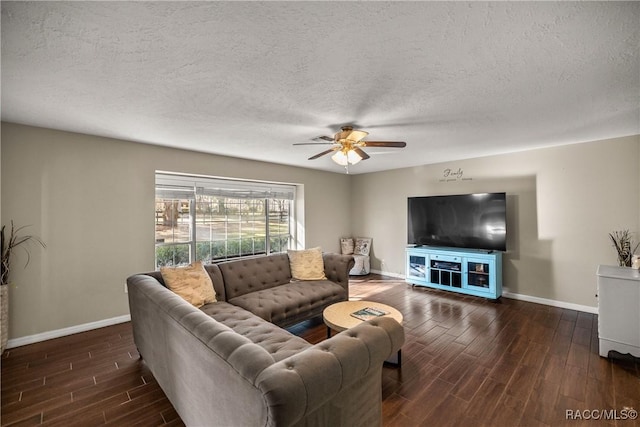 living area featuring a textured ceiling, wood finished floors, a ceiling fan, and baseboards