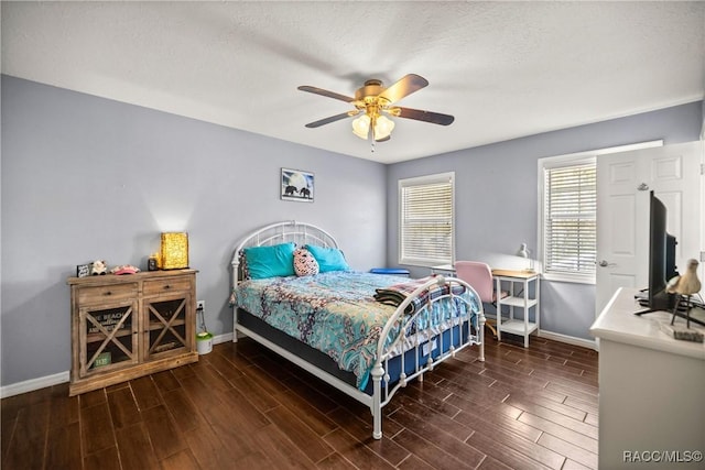 bedroom featuring wood tiled floor, ceiling fan, a textured ceiling, and baseboards