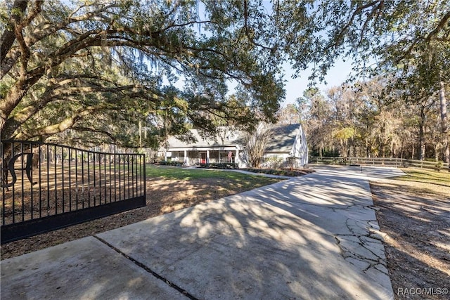 view of front of home featuring fence and a gate