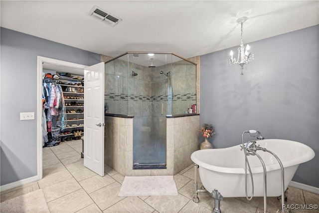 bathroom featuring visible vents, baseboards, a freestanding bath, a spacious closet, and a shower stall