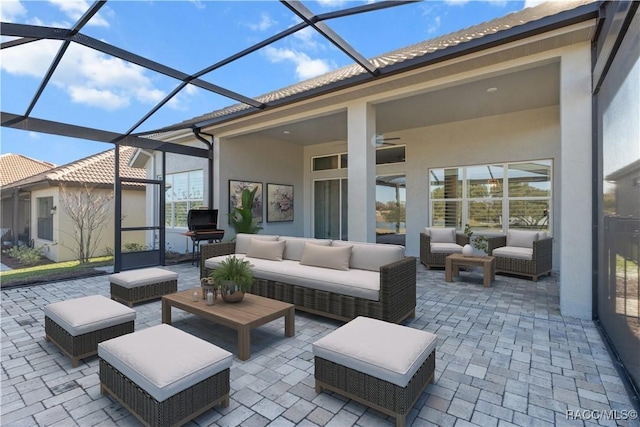 view of patio featuring outdoor lounge area and glass enclosure