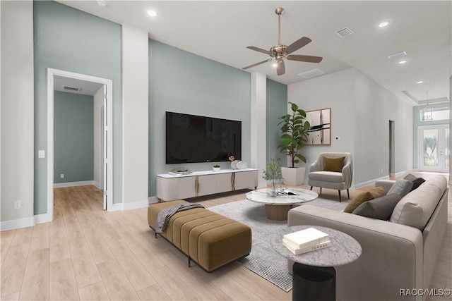 living room featuring ceiling fan and light hardwood / wood-style floors