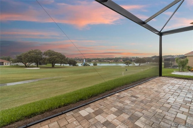 exterior space with a water view and a lawn