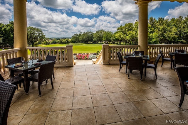 view of patio / terrace featuring view of golf course and outdoor dining area