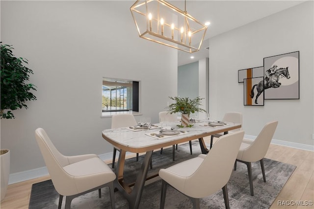 dining space with a chandelier, light wood finished floors, recessed lighting, and baseboards