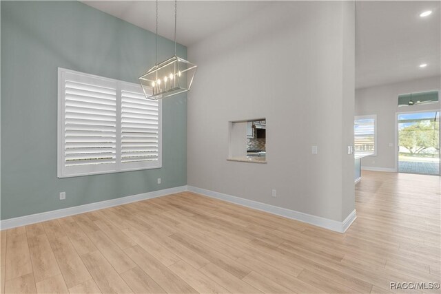 bedroom with light wood finished floors, ceiling fan, and baseboards