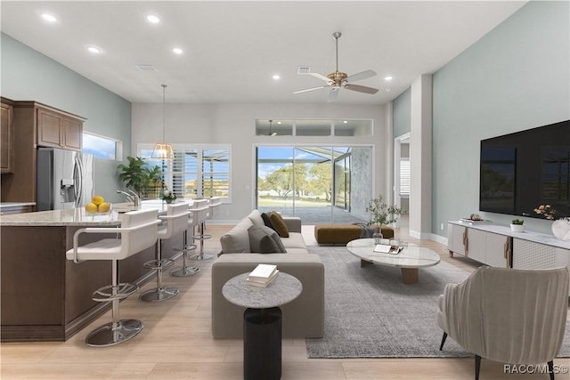 living room with recessed lighting, a ceiling fan, and a healthy amount of sunlight